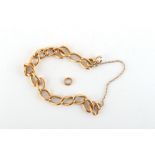 Property of a lady - an unmarked yellow gold (tests 18ct) chain link bracelet, with one loose