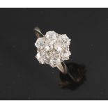 An 18ct white gold diamond flowerhead cluster ring, the Old European cut diamonds weighing a total