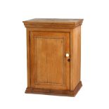 Property of a deceased estate - a pine panelled single door cupboard, 25.6ins. (65cms.) wide (