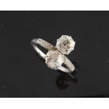 Property of a lady - an unmarked platinum or white gold diamond two stone ring, the brilliant cut