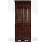Property of a lady - a George III & later carved oak two-part freestanding corner cabinet, enclosing