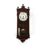 Property of a lady - a Comitti of London two-train wall clock, 25ins. (64cms.) high.