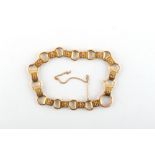 Property of a gentleman - a yellow gold (the flat links test 18ct) link bracelet, the clasp probably