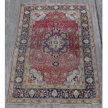 Property of a gentleman - a Persian hand-knotted wool carpet, with burgundy field, 118 by 79ins. (