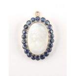 A fine moonstone & sapphire cameo pendant, the large carved oval moonstone depicting the bust of a