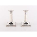 Property of a deceased estate - a pair of early 20th century silver dwarf candlesticks, Goldsmiths &