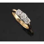 An 18ct yellow gold diamond three stone ring, the round brilliant cut diamonds weighing a total of