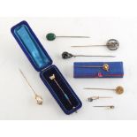 Property of a gentleman - a Chinese 20ct gold horseshoe stick pin set with a pearl, approximately