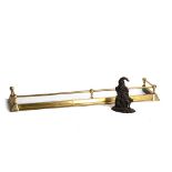 Property of a lady - an Edwardian brass adjustable fender; together with a cast iron Mr Punch