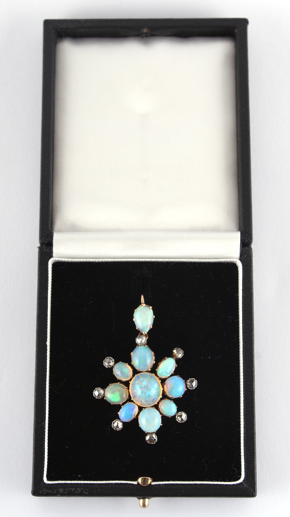 A black opal & diamond star or flowerhead pendant, approximately 47mm long (overall), in fitted box.