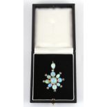 A black opal & diamond star or flowerhead pendant, approximately 47mm long (overall), in fitted box.