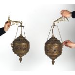 Property of a lady - a pair of Eastern brass hanging lanterns, with later associated brass wall
