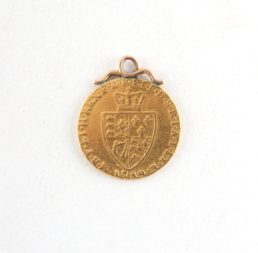 Property of a gentleman - gold coin - a 1789 George III spade guinea, adapted as a pendant.