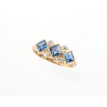 An 18ct yellow gold sapphire & diamond ring, set with three square cut sapphires in diamond