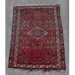 Property of a gentleman - a Persian hand-knotted wool rug with burgundy ground, 78 by 56ins. (188 by