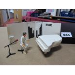 John Lennon White Metal Figure Set, comprising of a seated John Lennon, microphone, white piano,
