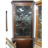 An Edwardian Inlaid Mahogany Double Corner Cupboard, the top with a glazed astragal door, three
