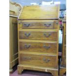 A Yew Wood Bureau, with a crossbanded fall, fitted interior, four long drawers, on bracket feet.