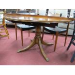 Yew Wood Circular Topped Dining Table, on four swept legs.