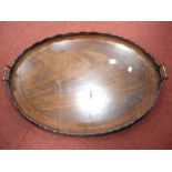 Edwardian Inland Mahogany Oval Tray, with scalloped galery and brass handles, 73cm wide (damages).