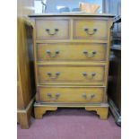 A Yew Wood Chest of Drawers, with a crossbanded top, two small drawers, three long drawers, reeded