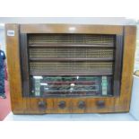 A Walnut Cased Radio by United, circa mid XX Century having Bakelite tuning knobs.