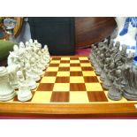 A Resin Chess Set, featuring classical pieces and wooden board.