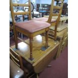 A Pine Drop Leaf Pedestal Table, on swept legs; together with four Ducal pine chairs, with rail