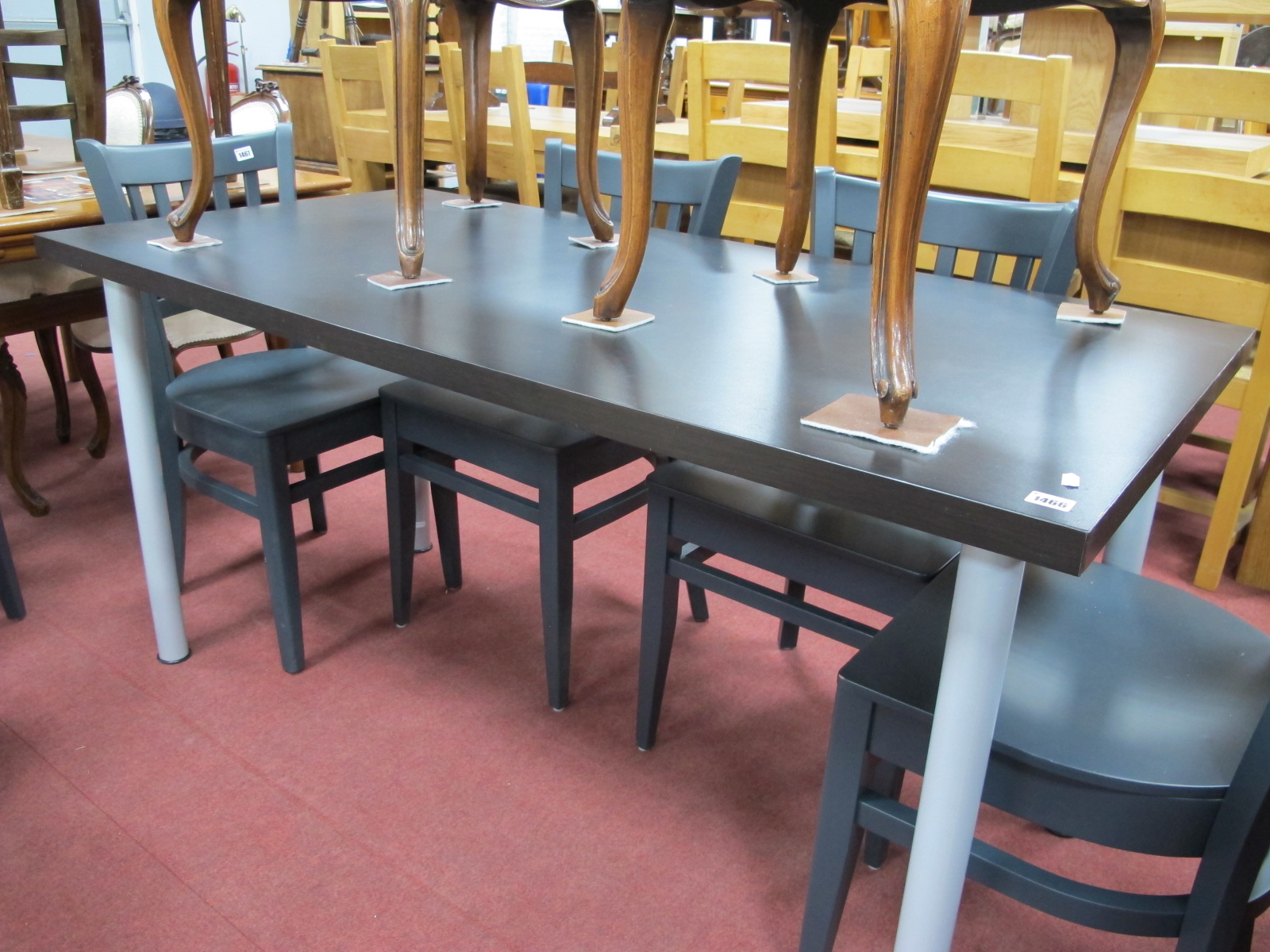 A Kitchen Table, with an ebonised top on tubular legs.