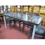 A Kitchen Table, with an ebonised top on tubular legs.