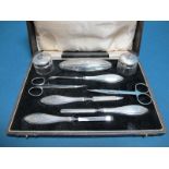 A Matched Hallmarked Silver Mounted Manicure Set, H&HLd, Birmingham 1929, 1931, engine turned and