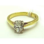 An Oval Cut Single Stone Diamond Ring, four claw set, stamped "750". *Coster Diamond Certificate