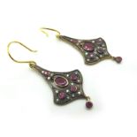 A Pair of Antique Style Ruby and Diamond Set Drop Earrings, of elongated tapered design, oval collet