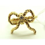 A Modern Franklin Mint Single Stone Diamond Set "Reminder Ring", as a tied bow, stamped "14",