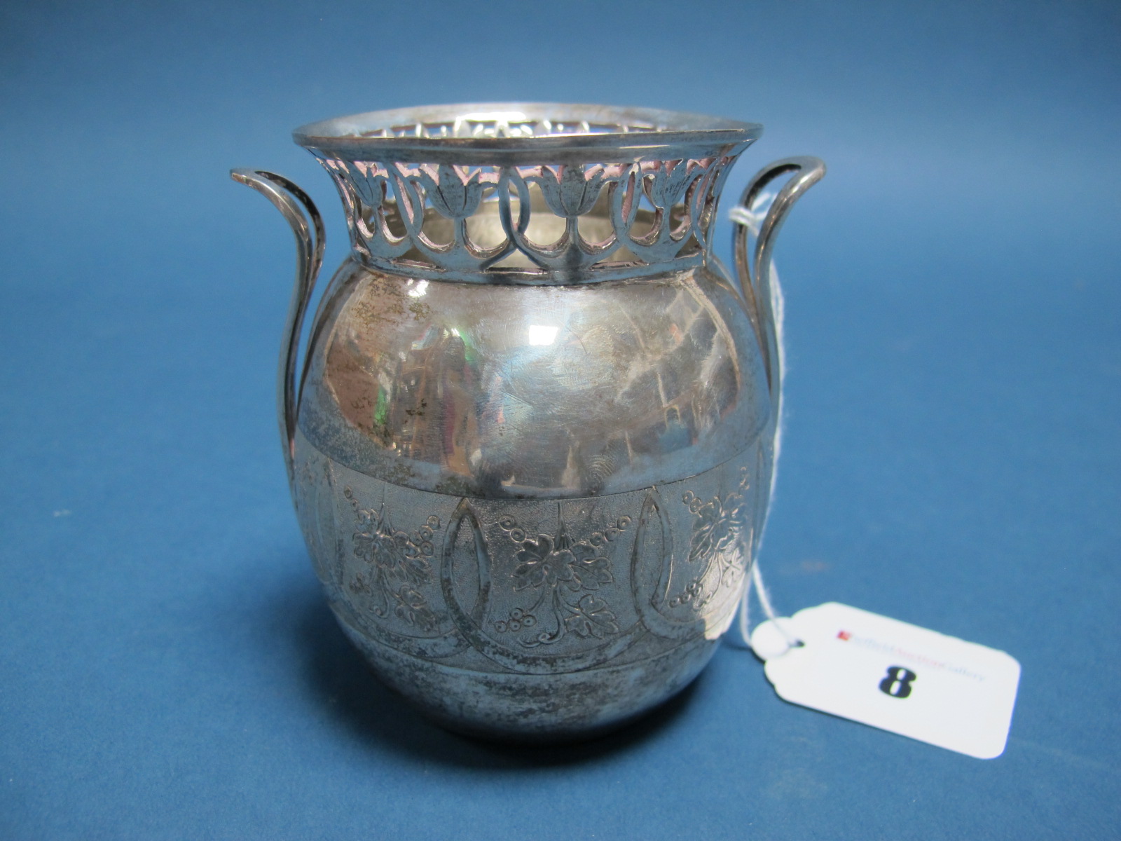 An Austrian Vase, with foliate band and geometric pierced rim, between twin loop handles, stamped