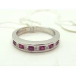 An 18ct White Gold Princess Cut Diamond and Ruby Set Half Eternity Style Band, alternately channel