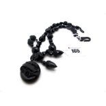 A Victorian Jet Necklace, composed of 'rose cut' circular links and black glass spacers,