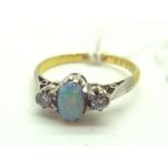 An Opal and Diamond Three Stone Ring, oval cabochon claw set to the centre, between two claw set