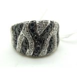 A Modern 18ct White Gold Black and White Diamond Set Cocktail Dress Ring, of tapered zebra design.