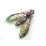 A Modern Ruby Set Insect Brooch, circular and oval collet rubover set, with marcasite set body,