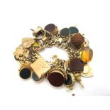 A 9ct Gold Link Charm Bracelet, to 9ct gold heart shape padlock clasp, suspending numerous hardstone