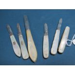 Four Hallmarked Silver and Mother of Pearl Single Blade Folding Fruit Knives; together with a larger