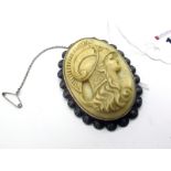 A XIX Century Oval Carved Ivory Cameo Style Brooch, depicting a centurion, oval collet set, within