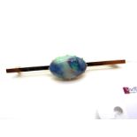 A Large Single Stone Opal Bar Brooch, oval claw set, on plain bar, 6.3cm long.