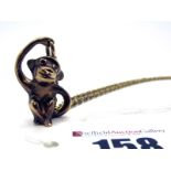 A Novelty 9ct Gold Monkey Pendant, with inset eyes, on a chain.