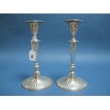 A Pair of Hallmarked Silver Candlesticks, each of tapering panelled form with reeded detail and