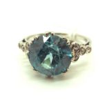 A Large Blue Zircon and Diamond Set Dress Ring, multi claw set to the centre, between eight