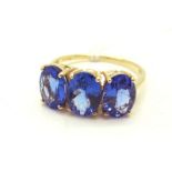 A Modern 14ct Gold Three Stone Tanzanite Dress Ring, claw set with uniform oval stones. *Gemporia