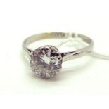 A Single Stone Diamond Ring, the (7mm) old brilliant cut stone six double claw set, stamped "PLAT".