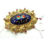 A Decorative Enamel Brooch, of shaped oval textured design, the central oval panel highlighted in